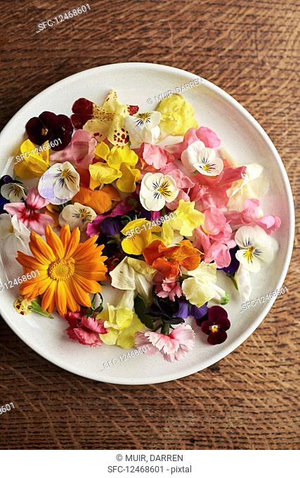 Edible flowers on a plate seen from above