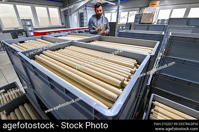 28 January 2021, Saxony, Markneukirchen: Denny Liebel, production manager, controls the manufacture of drumsticks in the production of Rohema Percussion in...
