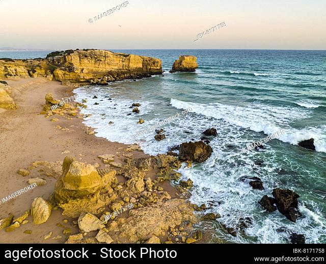 Aerial view of cliffs on Sao Rafael beach by the Atlantic Ocean at sunset, Algarve, Portugal, Europe