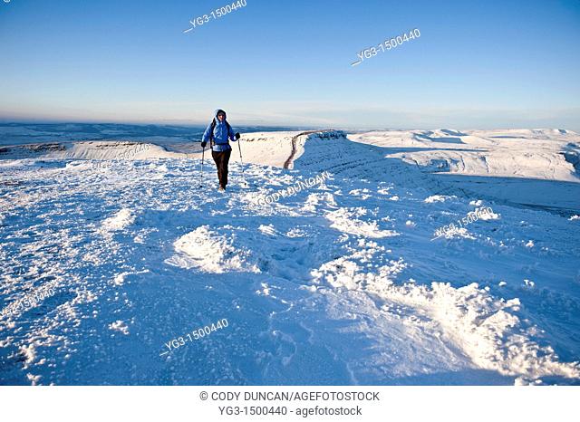 Single female hiker of Snow covered summit of Pen Y Fan, Brecon Beacons national park, Wales