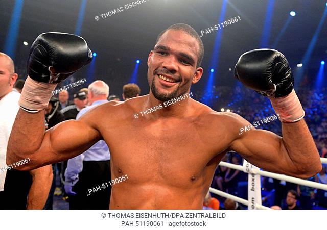 Title holder Yoan Pablo Hernandez (C) from Germany cheers after his fight against his German challenger Firat Arslan for the IBF World Champion cruiserweight...