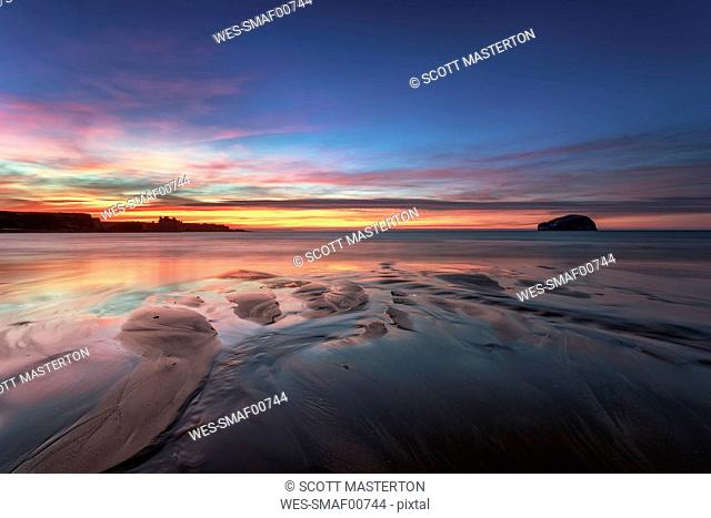 UK, Scotland, East Lothian, Bass Rock and Tantallon Castle at sunset from Seacliff beach