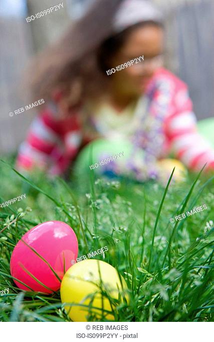 Girl looking for easter eggs in grass