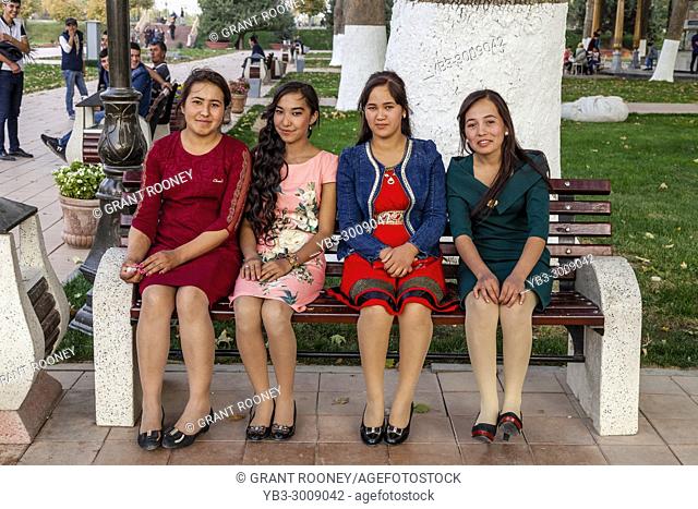 A Group Of Young Uzbek Women Sitting On A Bench, Samarkand, Uzbekistan