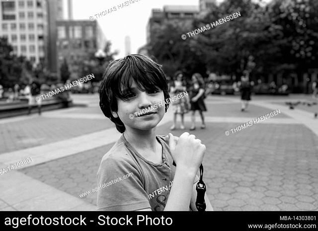 Greenwich Village, New York City, NY, USA, 12 years old caucasian teenager boy - with brown hair and in summer outfit somewhere in NYC