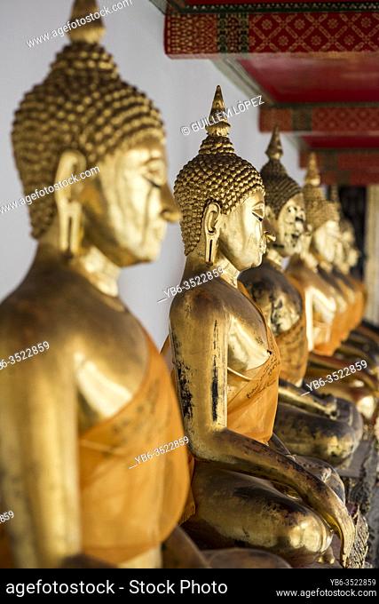 Row of golden Buddha statues at the Wat Pho temple, Bangkok, Thailand