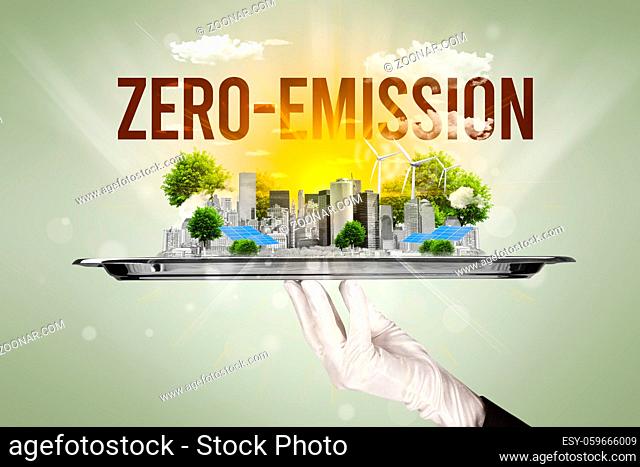 Waiter serving eco city with ZERO-EMISSION inscription, renewabke energy concept