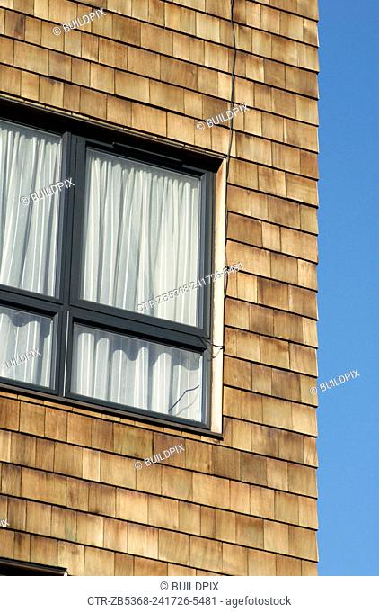 Cedar shingle cladding on a modern mixed-use development, London, UK