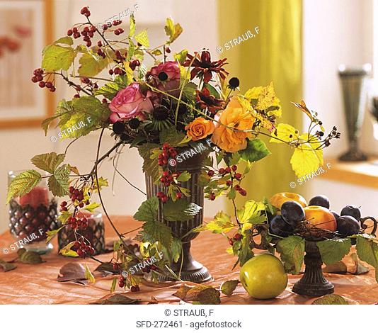 Vase of roses, purple coneflower seed heads & hawthorn
