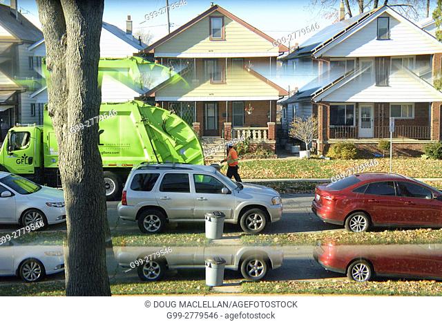 Garbage pick up day as seen through a front door window giving a split image, Windsor, Ontario