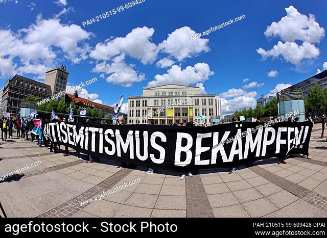 15 May 2021, Saxony, Leipzig: Pro-Israel demonstrators and supporters hold a banner with the inscription ""Fight anti-Semitism""