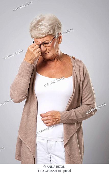 Senior woman suffering from strong headache. Debica, Poland