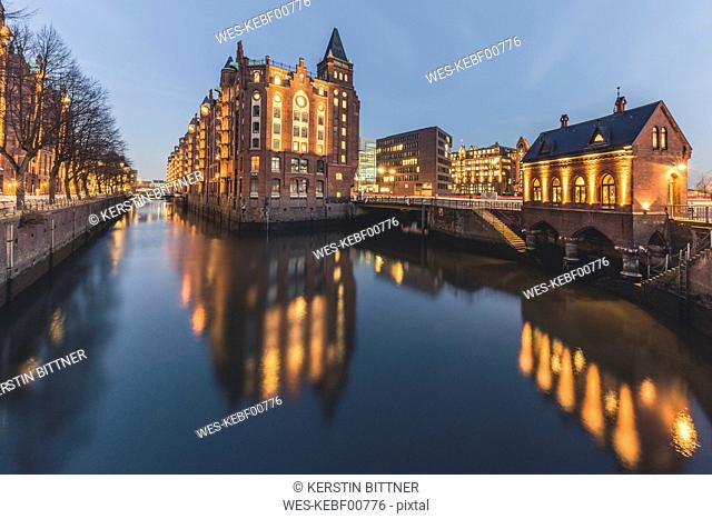 Germany, Hamburg, Speicherstadt, lighted building Fleetschloesschen in the evening