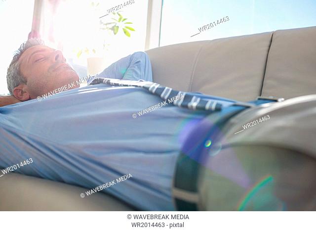 Businessman relaxing on a couch