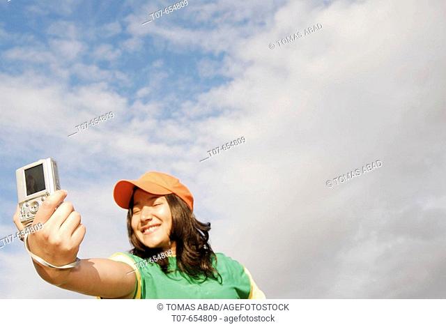 Latino woman holding digital camera