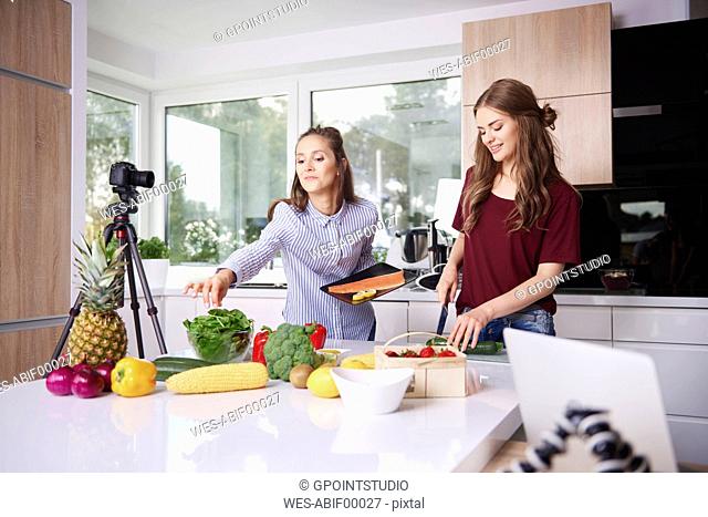 Bloggers cooking in modern kitchen