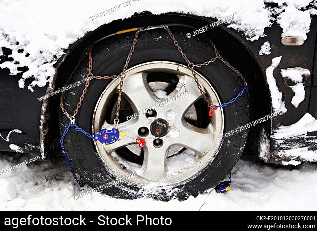 An illustrative photo of snow chains being mounted on the tire, Prague, Czech Republic, on Friday, Dec. 1, 2010. (CTK Photo/Josef Horazny)