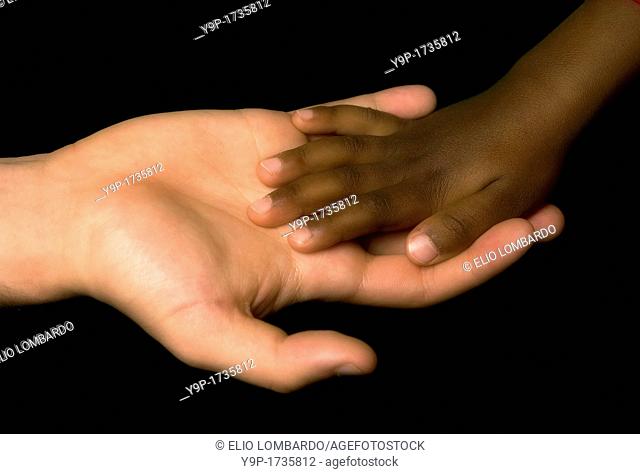 White woman's hand receive the black child's hand