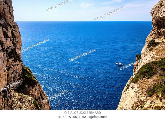 Alghero, Sardinia / Italy - 2018/08/11: Panoramic view of the Gulf of Alghero with cliffs of Cape Cappo Caccia over the Neptuneâ€™s Grotto