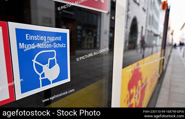 10 January 2023, Thuringia, Erfurt: ""Entry only with mouth-nose protection"" can be read on the door of a streetcar. On February 3