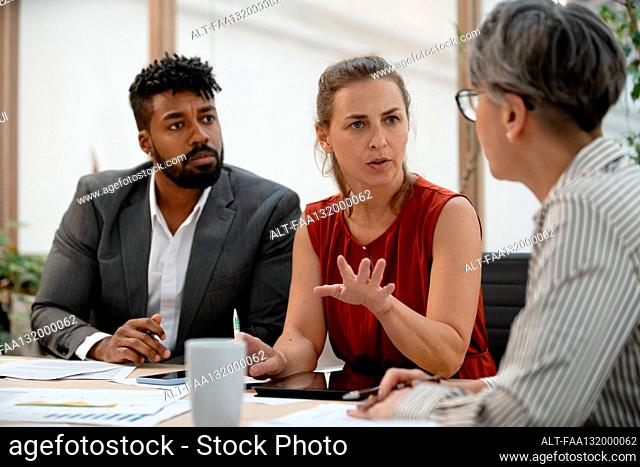 Businesswoman discussing over business chart with colleague