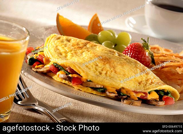 Mushroom, Tomato and Cheese Omelette with Fruit and Hash Browns