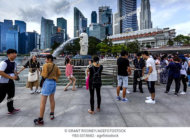 Tourists Taking Photos Of The Merlion Statue and Singapore Skyline, Singapore, South East Asia