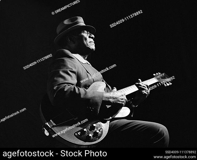 African American man playing guitar
