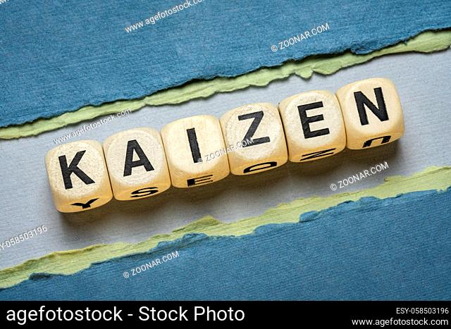 kaizen word abstract in wooden letter cubes against paper abstract in green tones, Japanese continuous improvement and a change for better concept