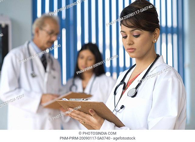 Doctors examining a report, Gurgaon, Haryana, India