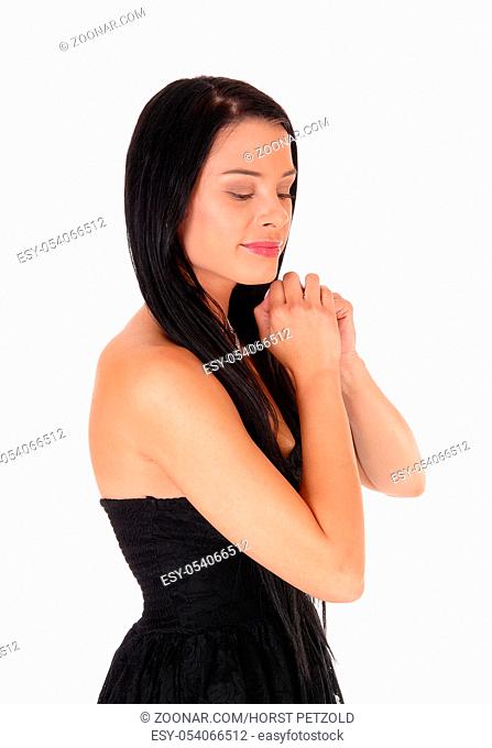 A close up image of a beautiful woman praying with her hands folded and long black hair, eye's are closed, isolated for white background