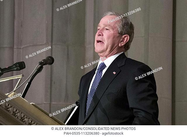 Former President George W. Bush fights back tears as he speaks during the State Funeral for his father, former President George H.W