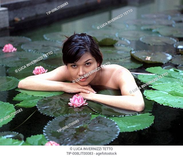 Woman in pool with water-lilies