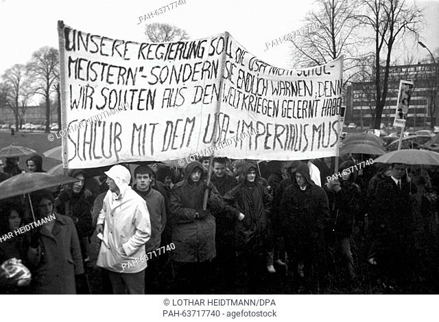 Despite the heavy rain, about 1, 200 people gather at Moorweide in front of train station Dammtor in Hamburg to demonstrate against Vietnam War on 22 March 1968