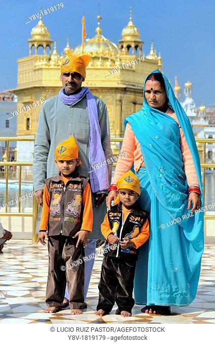 India. Punjab. Amritsar. The Golden Temple. Believers Sikh in front of the sacred pool Anrit Sarovar and the Sri Harmandir Sahib the holy of holies of Sikhism