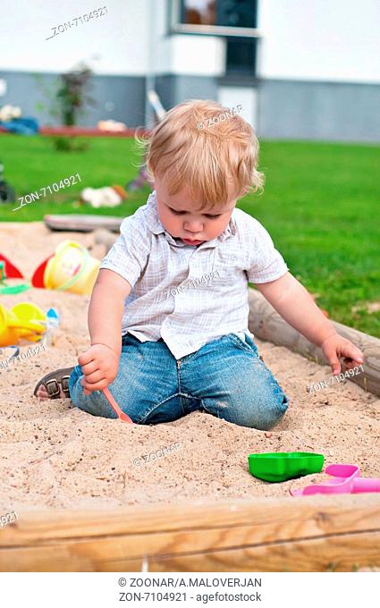 Child playing on playground in sandbox