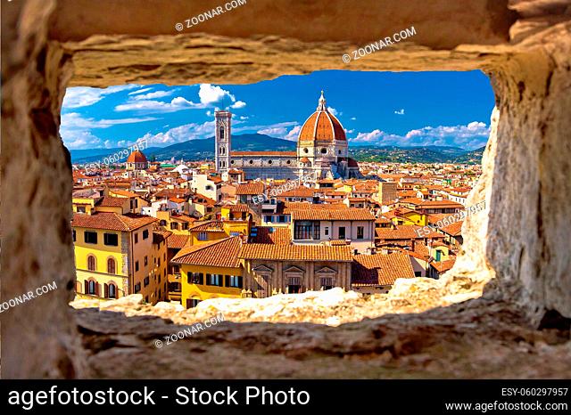 Florence square and cathedral di Santa Maria del Fiore or Duomo view through stone window, Tuscany region of Italy