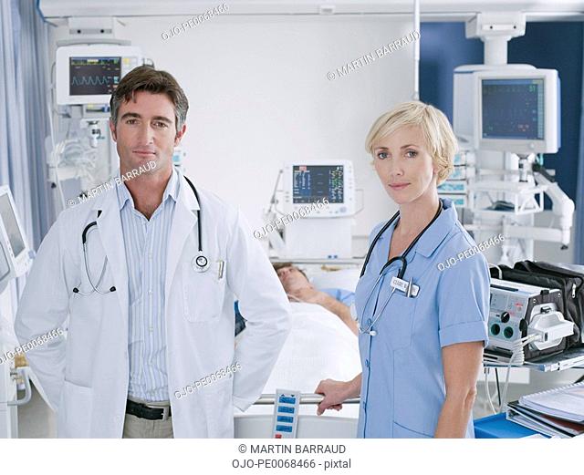 Doctor and nurse standing in intensive care
