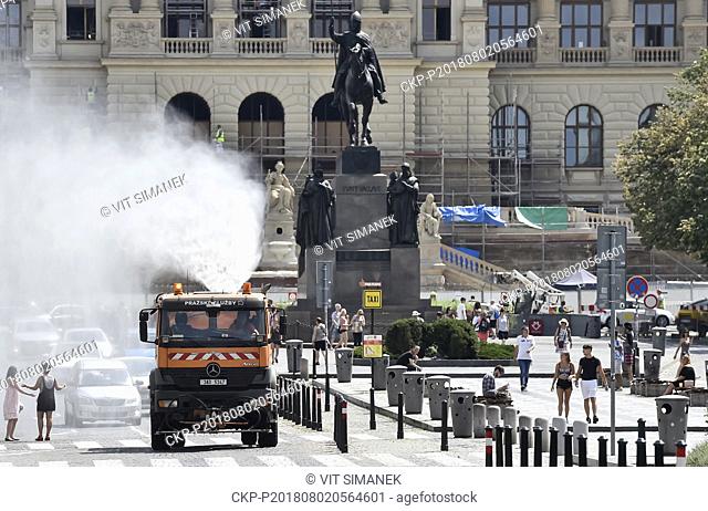 Sprinkler truck goes spraying water in extremely hot day at Wenceslas Square in Prague, Czech Republic on August 2nd, 2018
