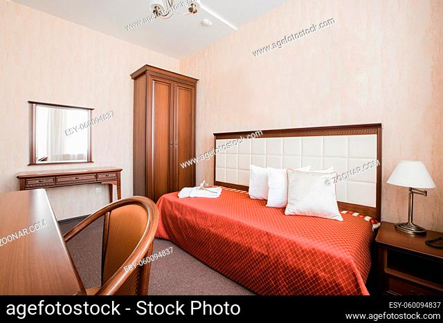Hotel apartment, bedroom interior in the morning. single room, with bed