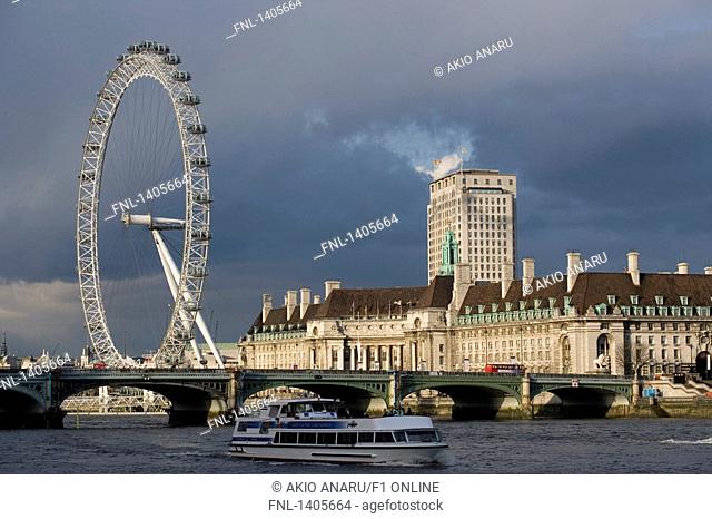 Brdige across river with ferris wheel, Thames River, Millennium Wheel, London, England