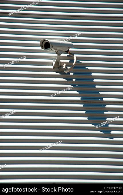 Surveillance Camera casts a shadow on a wall