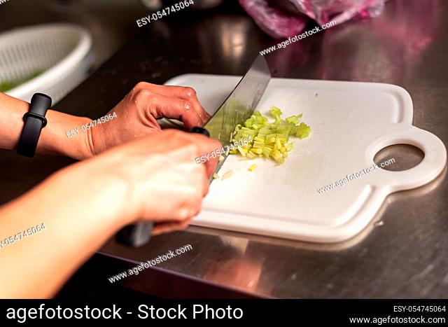 woman cut vegetables on the table at home