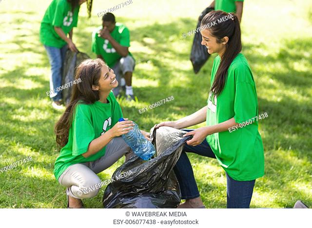 Team of volunteers picking up litter in park