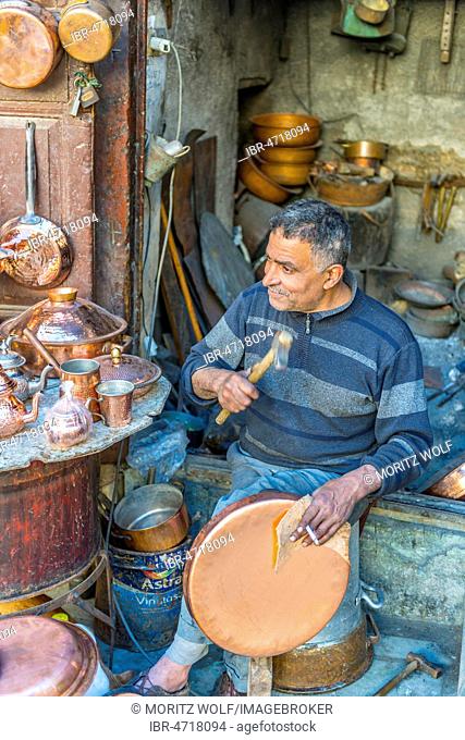 Coppersmith at work, copper market, Seffarine Square, Fes el Bali, Fez, Morocco
