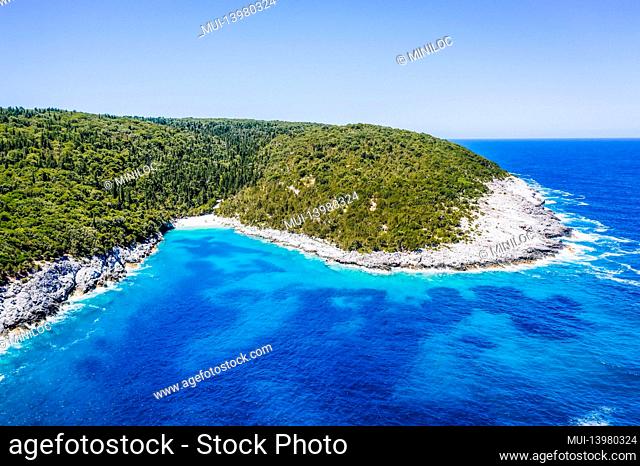 Aerial view of remote Dafnoudi beach in Kefalonia, Greece, Secluded bay with pure crystal clean turquoise sea water surrounded by cypress trees