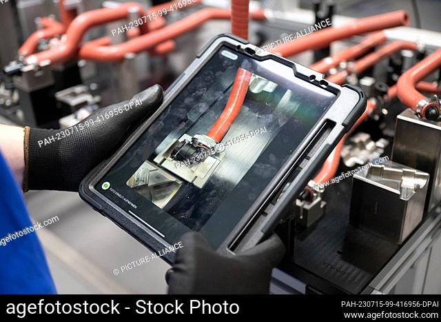 PRODUCTION - 12 July 2023, Baden-Württemberg, Stuttgart: A Robert Bosch GmbH employee checks hose clamps for a fuel cell drive system for generating electricity...