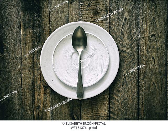 Dish and spoon on wood