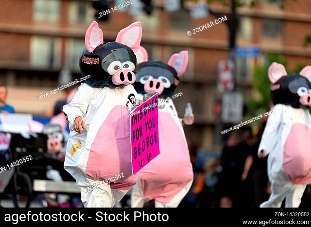 Louisville, Kentucky, USA - May 2, 2019: The Pegasus Parade, women dress up as pigs, promoting Rubbies grill and bar during the parade