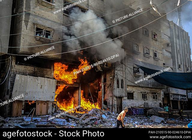 15 May 2021, Palestinian Territories, Rafah: A fire breaks out at a house hit by an Israeli airstrike on Rafah, amid the escalating flare-up of...